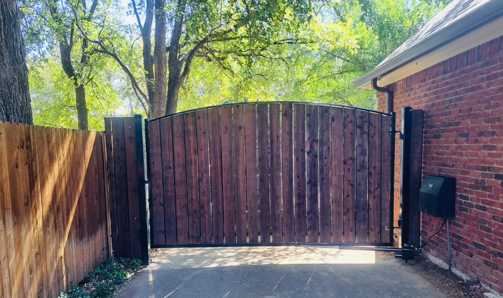 Automatic Gate Operator on a Cedar Driveway Gate completed by Affordable Fencing in Alvord, TX