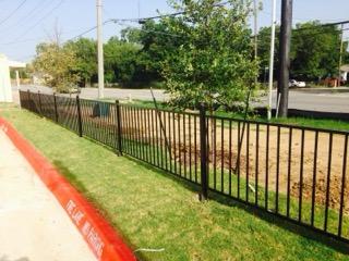 Black Iron Fence Along a Commercial Property Line completed by Affordable Fencing in Azle, TX