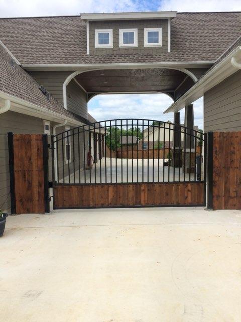 Arched Wrought Iron Gate with Cedar Panels completed by Affordable Fencing in Decatur, TX