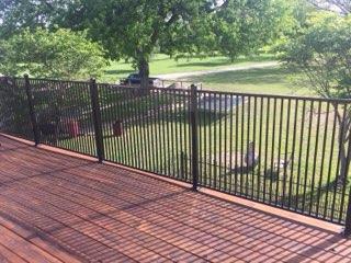 Black ornamental iron deck railing overlooking a Decatur, TX backyard