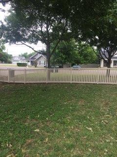 White picket-style wood fence bordering a Decatur, TX lawn