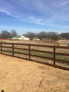 Rust-toned pipe rail corral fencing on a Wise County ranch